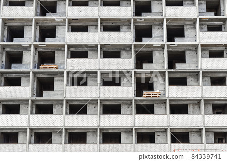 Seven high buildings under construction with cranes at evening 84339741