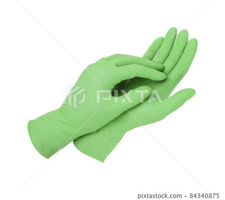 Medical gloves. Two green surgical gloves isolated on white background with hands. Rubber glove manufacturing, human hand is wearing a latex glove. Doctor or nurse putting on protective gloves. 84340875