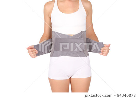 Orthopedic lumbar corset on the human body. Back brace, waist support belt for back. Posture Corrector For Back Clavicle Spine. Post-operative Hernia Pregnant and Postnatal Lumbar brace after surgery. 84340878