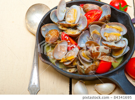 fresh clams on an iron skillet 84341695