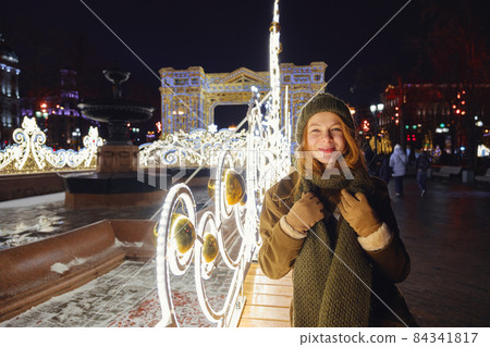 young beautiful happy smiling woman posing on the street. 84341817