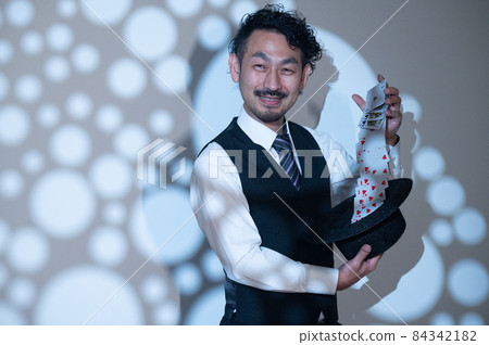 A full-fledged magician performing on stage A full-fledged magician performing on stage 84342182
