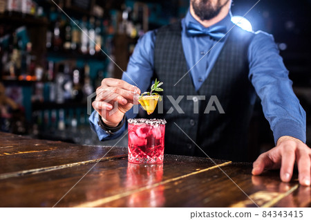 Barman makes a cocktail at the taproom Barman makes a cocktail at the taproom 84343415