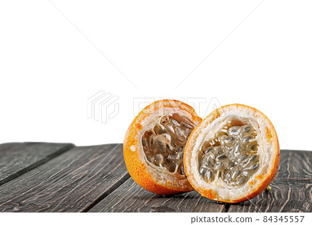 Two halves of tamarillo on wooden table Two halves of tamarillo on wooden table 84345557