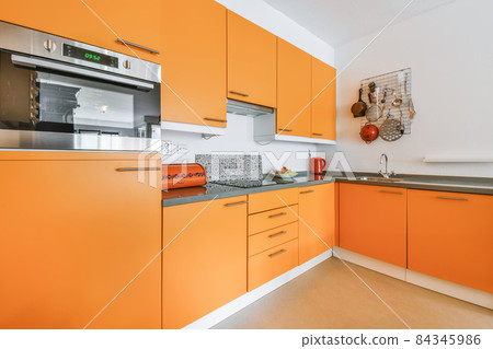 Stylish kitchen design with orange kitchen set 84345986