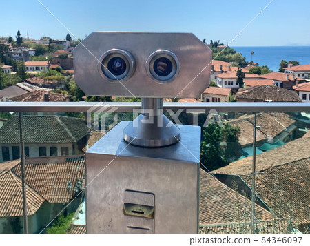 Coin Operated Binocular viewer next to the waterside promenade in Phuket looking out to the Bay. Landscape with beautiful cloudy sky and sea Coin Operated Binocular viewer next to the waterside promenade in Phuket looking out to the Bay. Landscape with beautiful cloudy sky and sea 84346097