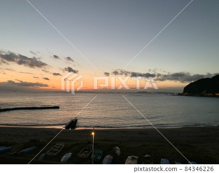 Sunset sky with floating clouds and beach with calm waves Photo material 84346226