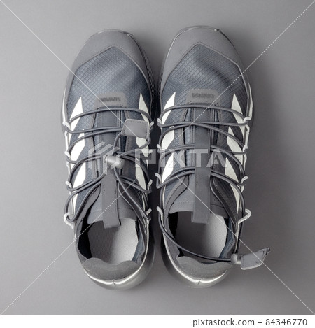 New black sneakers with laces for run on a gray background. Top view New black sneakers with laces for run on a gray background. Top view 84346770