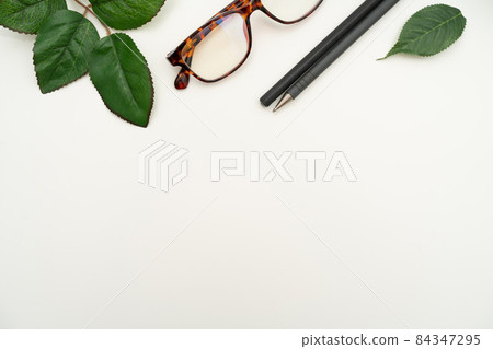 Office Supplies Over Desk With Keyboard And Glasses And Coffee Cup For Working Remotely, Assorted School Utilities For Studying With Hot Drink And Eyeglasses. Office Supplies Over Desk With Keyboard And Glasses And Coffee Cup For Working Remotely, Assorted School Utilities For Studying With Hot Drink And Eyeglasses. 84347295