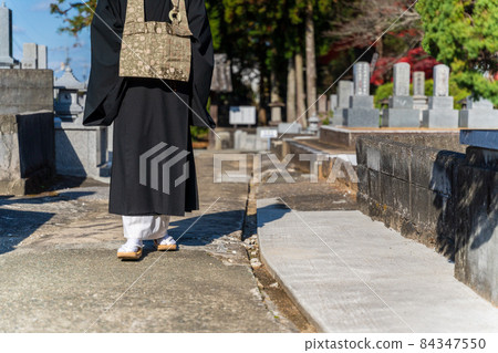 Monk walking in the graveyard Monk walking in the graveyard 84347550