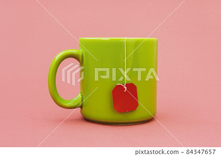 Green mug with red teabag label 84347657