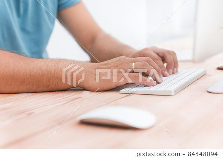close up. a man typing on a computer keyboard 84348094