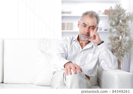 dreamy adult businessman sitting on sofa in office 84349261
