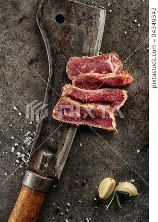 Grilled beef steak fillet with ingredients and herbs on black board, product image for restaurant Grilled beef steak fillet with ingredients and herbs on black board, product image for restaurant 84349342