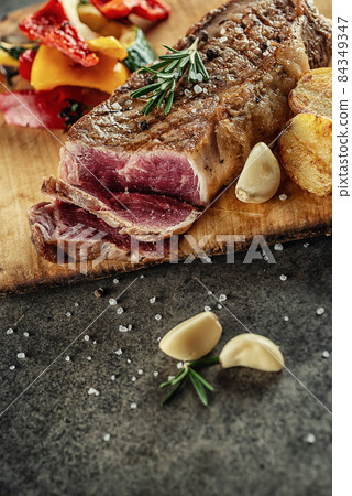 Grilled beef steak fillet with ingredients and herbs on black board, product image for restaurant Grilled beef steak fillet with ingredients and herbs on black board, product image for restaurant 84349347