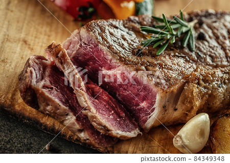 Grilled beef steak fillet with ingredients and herbs on black board, product image for restaurant Grilled beef steak fillet with ingredients and herbs on black board, product image for restaurant 84349348