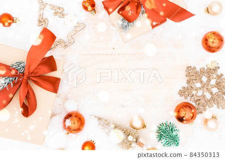 Christmas frame. Winter wooden decoration background. Xmas board with old rustic wall, white frozen snow, golden balls and gift box. Top view with copy space. Christmas frame. Winter wooden decoration background. Xmas board with old rustic wall, white frozen snow, golden balls and gift box. Top view with copy space. 84350313