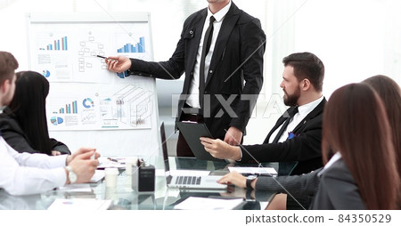 Finance Manager pointing a marker on the flipchart with financial data 84350529