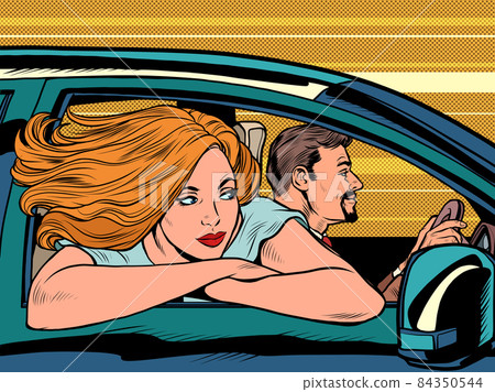 a woman looks out of a car window, her hair fluttering in the wind. husband driving 84350544