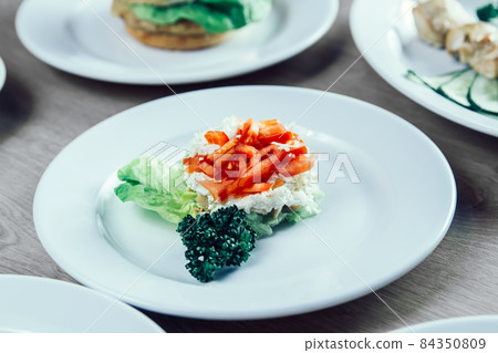 hamburger, vegetable salad and other dishes on the table in the restaurant hamburger, vegetable salad and other dishes on the table in the restaurant 84350809