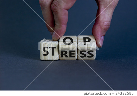 Stop stress and be health symbol. Doctor turns cubes and changes words 'stress' to 'stop'. Beautiful grey background. Psychological, business and stop stress concept. Copy space. 84352593