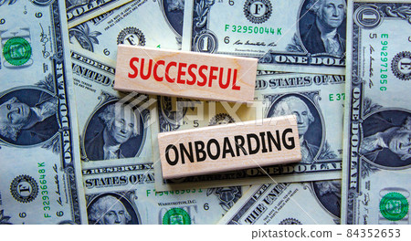 Successful onboarding symbol. Wooden blocks with words 'Successful onboarding'. Beautiful background from dollar bills. Business, successful onboarding concept, copy space. 84352653