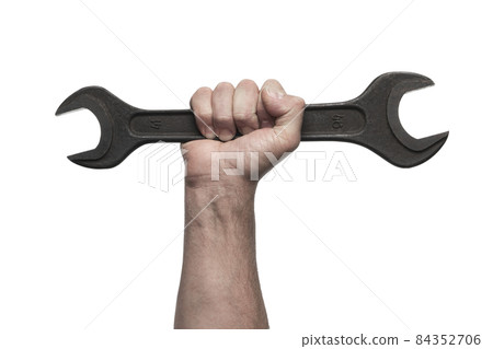 Male worker's hand holds a large wrench isolated on white 84352706