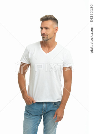 Serious handsome man in casual tshirt keep hand in pocket isolated on white, dude Serious handsome man in casual tshirt keep hand in pocket isolated on white, dude 84353186