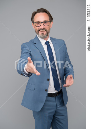 Extend a hand in a welcome gesture. handsome Extend a hand in a welcome gesture. handsome 84353241