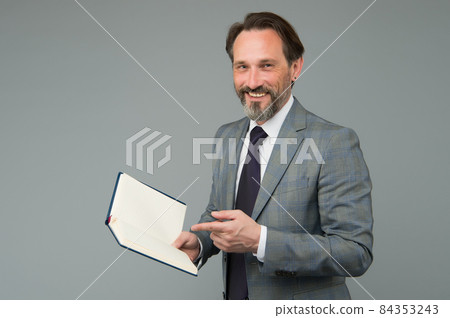 happy man in suit with book. accountant maintains happy man in suit with book. accountant maintains 84353243