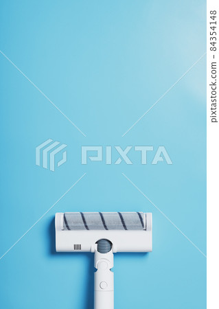 White vacuum cleaner brush on a blue background, top view. Cleaning concept White vacuum cleaner brush on a blue background, top view. Cleaning concept 84354148