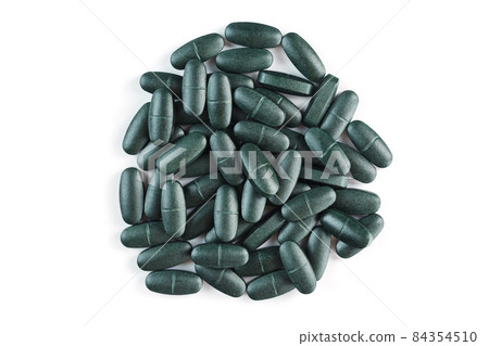 Pills with Vitamins and spirulina on a white background. 84354510