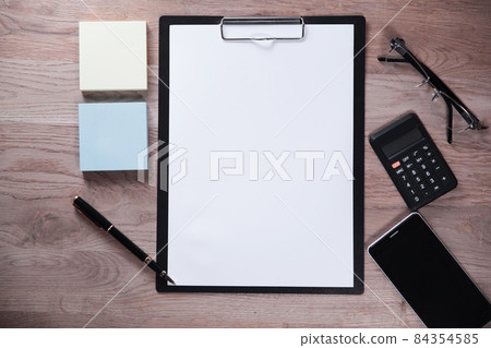 clipboard with blank sheet and business items on wooden background 84354585