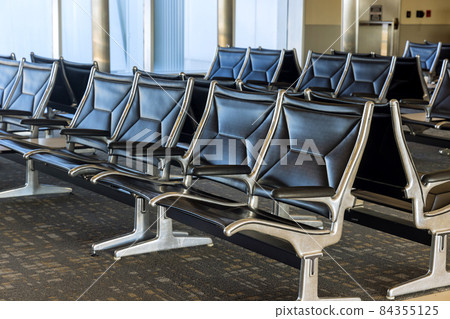 Empty airport terminal waiting area with seats in the departure lounge Empty airport terminal waiting area with seats in the departure lounge 84355125