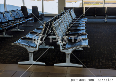 Empty seats in the departure lounge at the airport Empty seats in the departure lounge at the airport 84355127