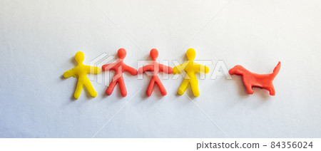 silhouettes of people and a dog made of dough on a light background silhouettes of people and a dog made of dough on a light background 84356024