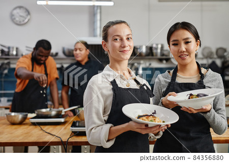 Waitresses Holding Gourmet Dishes Waitresses Holding Gourmet Dishes 84356880