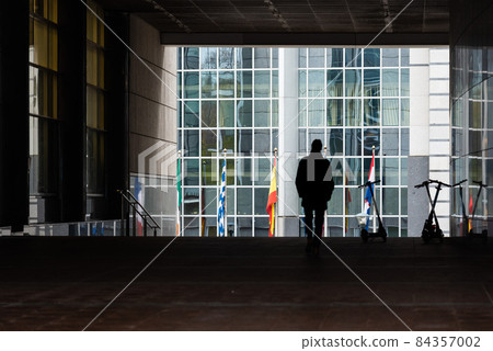 Ixelles, Brussels Capital Region, Belgium - 11 19 2021: Conceptual picture of a man silhouette walking through the tunnel of the European Parliament 84357002