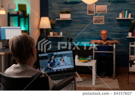 Senior adult talking on video call conference Senior adult talking on video call conference 84357607