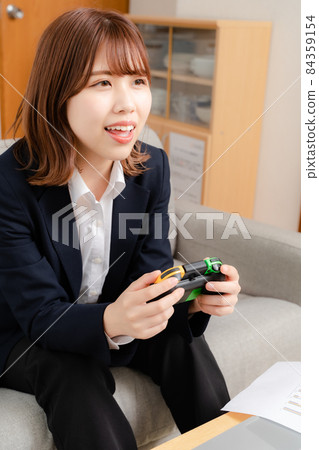 A woman playing games while working from home 84359154