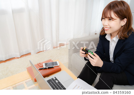 A woman playing games while working from home 84359160