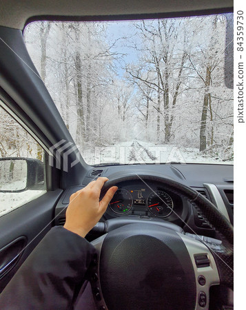 ride on car by frozen road in the forest ride on car by frozen road in the forest 84359730