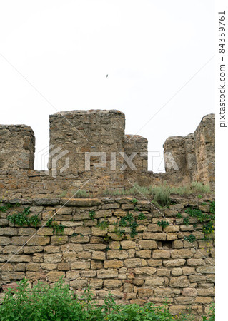 The fortress wall is made of natural stone. Ancient limestone stone. Creative vintage background. Ukraine. Belgorod - Dnestrovsky. 84359761