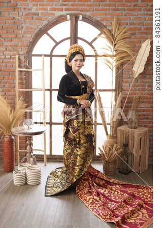 standing woman black Balinese Kebaya against large window background standing woman black Balinese Kebaya against large window background 84361191