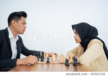 Man and woman looking at each other during playing chess Man and woman looking at each other during playing chess 84361392