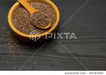 Bowl of organic natural chia seeds close-up on wooden background or table 84365893