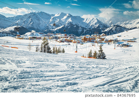 Ski tracks in the deep snow on the slope, France Ski tracks in the deep snow on the slope, France 84367695