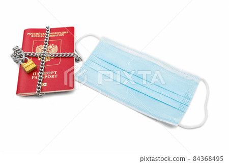 Passport with a medical mask on a white background. 84368495