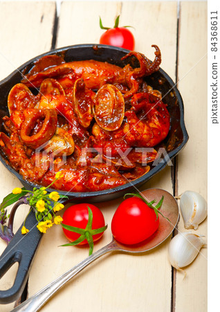 fresh seafoos stew on an iron skillet 84368611