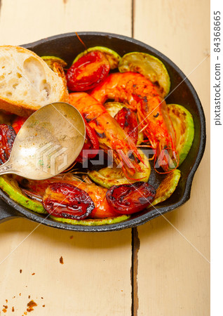 roasted shrimps with zucchini and tomatoes 84368665